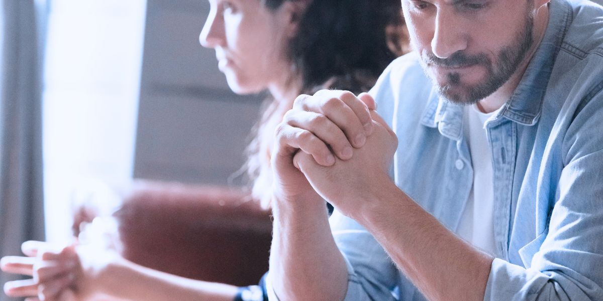 image of couple sitting on couch unhappy